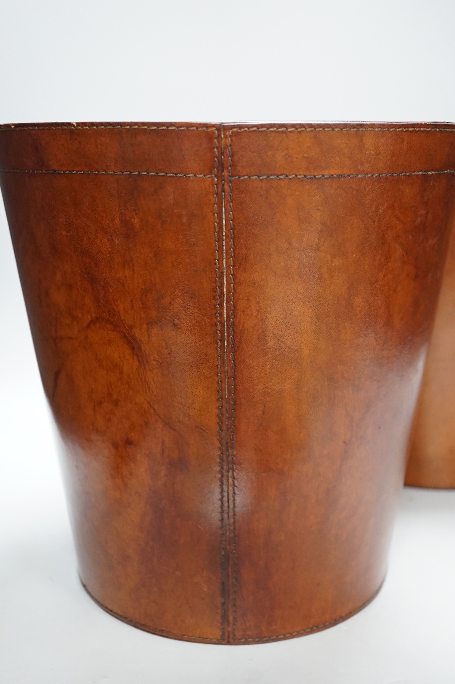 Two brown leather waste paper bins, 30cms high